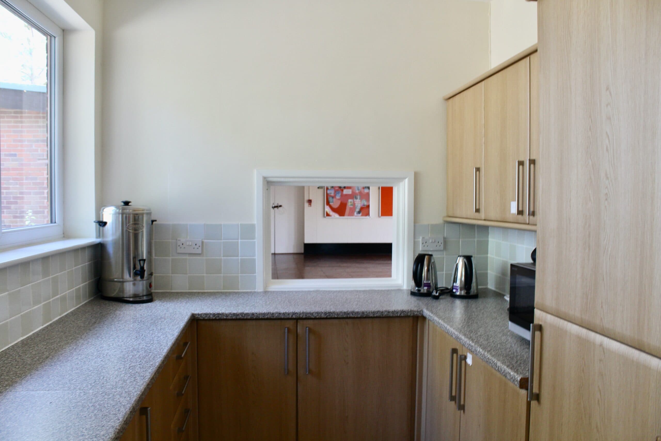 Kitchen servery hatch looking through to the main hall